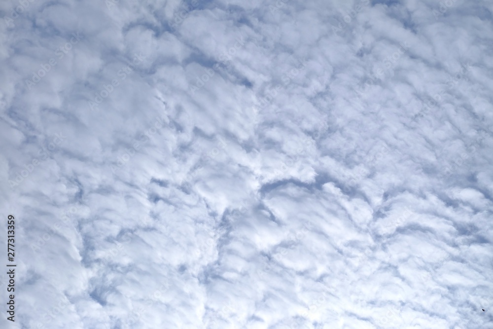 White cotton candy clouds against blue sky for background backdrop 