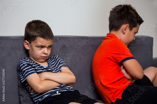 Принти на полотні Angry kid offended not talking ignoring brother after fight, jealous kid brother