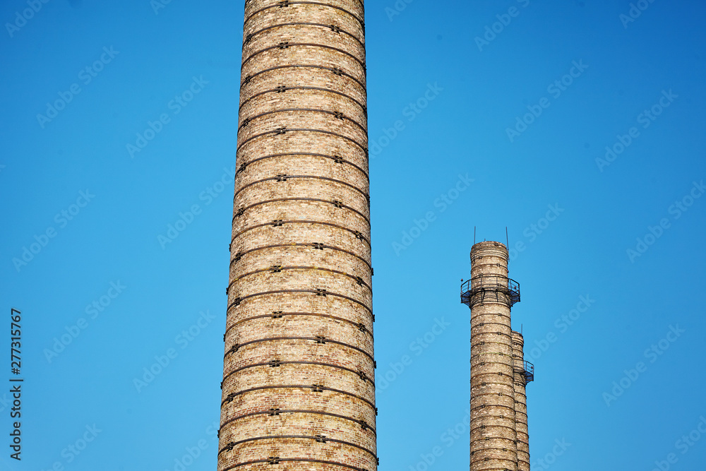 Brick chimneys in the factory. Industry, ecology.