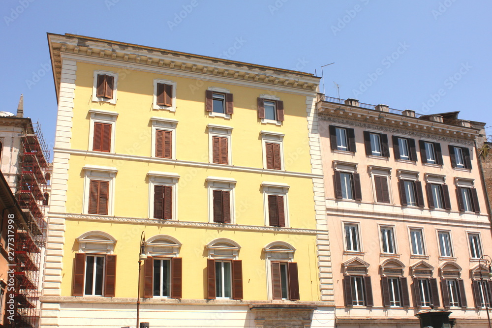 Traditional facade of European architecture with windows and blinds