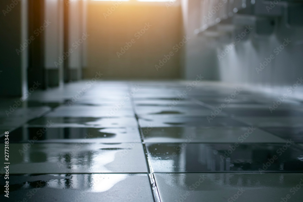 Spilled water leak on the floor of building. Wet floor from rainy