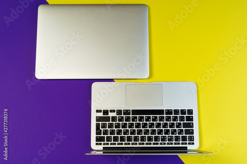 Minimal Laptop Yellow Purple Background Flat Lay. Two Computer Version Compare Top View. Office Workspace Minimalist Copy Space. Simple Hipster Desk Layout Modern Bright Concept. Creative Poster