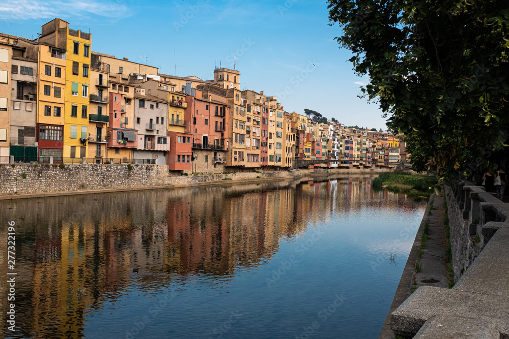 Girona main landmark river houses reflection on a blue sunny day