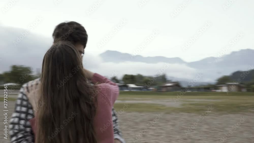 Dating couple dancing together at the lake and kissing Dating couple dancing together at the lake and kissing