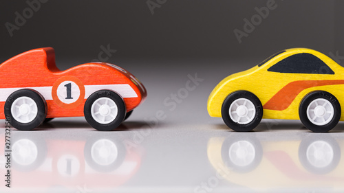 Fototapeta Naklejka Na Ścianę i Meble -  Tiny racing toy cars on a white board