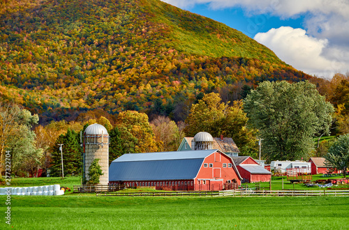 Farm with red barn and silos at sunny autumn day in West Arlington, Vermont, USA photo