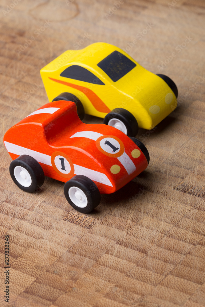 Red and yellow toy car on a wooden surface Red and yellow toy car on a wooden surface