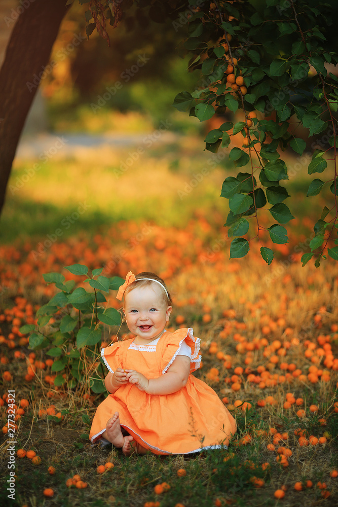 Little girl in orange dress with apricots Little girl in orange dress with apricots