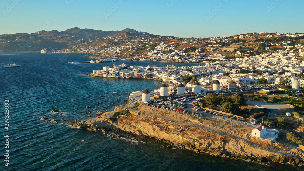Aerial drone photo of iconic windmills overlooking the Aegean sea in main town of Mykonos island, Cyclades, Greece