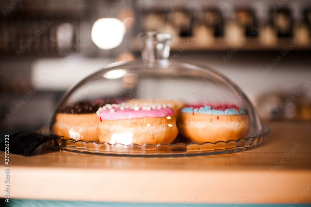 Fresh colorful donuts in cafe closeup Fresh colorful donuts in cafe closeup
