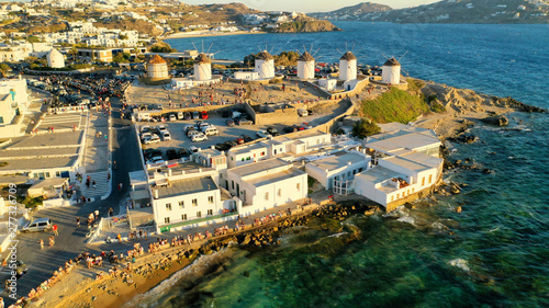 Aerial drone photo of iconic windmills overlooking the Aegean sea in main town of Mykonos island  Cyclades  Greece