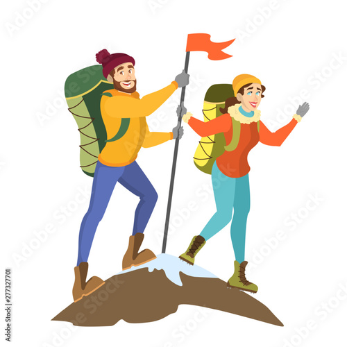 Climber couple standing on the mountain peak with flag