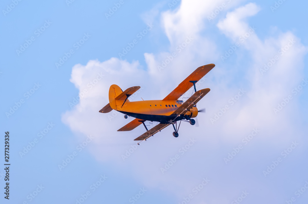View on an old plane flying againtst the blue sky View on an old plane flying againtst the blue sky
