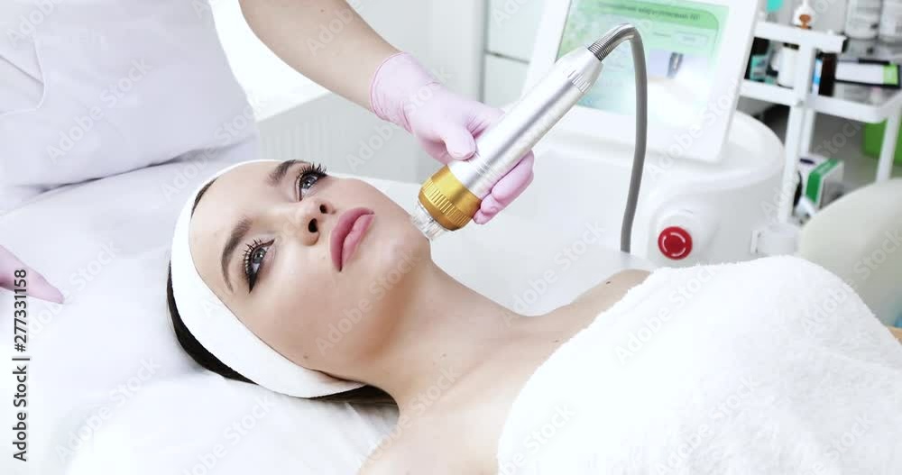 Beauty’s Woman getting microdermabrasion at Beauty Salon with special Equipment. Medical sterile white Cabinet. Woman enjoying the Beauty Procedure. Skin Care. Cosmetology. Healthy Beauty. Beauty’s Woman getting microdermabrasion at Beauty Salon with special Equipment. Medical sterile white Cabinet. Woman enjoying the Beauty Procedure. Skin Care. Cosmetology. Healthy Beauty.