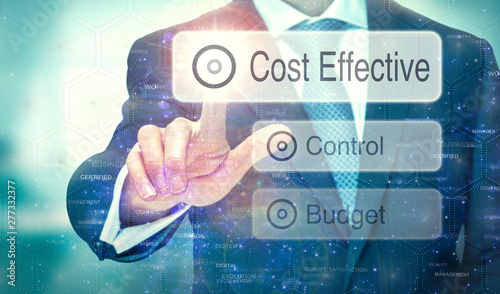 Obraz na płótnie A businessman selecting a button on a futuristic display with a Cost Effective concept written on it. w salonie