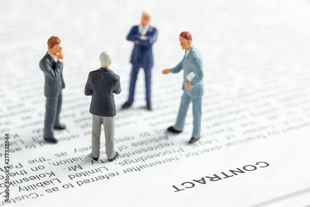 Group of businessmen in suit and tie are discussing contact. The conclusion of the contract between the companies Group of businessmen in suit and tie are discussing contact. The conclusion of the contract between the companies