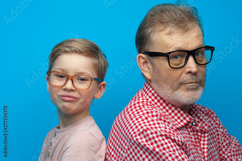 Portrait of cute positive grandfather and grandson