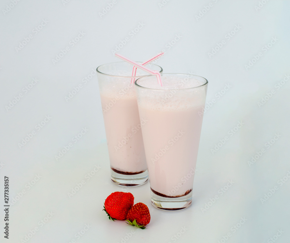 Strawberry cocktail or milk shake in a glass decorated with strawberries on the table. Healthy food for breakfast and snacks. Strawberry cocktail or milk shake in a glass decorated with strawberries on the table. Healthy food for breakfast and snacks.