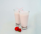 Strawberry cocktail or milk shake in a glass decorated with strawberries on the table. Healthy food for breakfast and snacks.