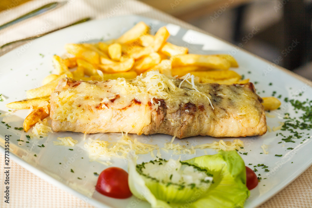 Traditional Montenegrin Meat Negush Steak on white plate in a restaurant. Traditional Montenegrin Meat Negush Steak on white plate in a restaurant.