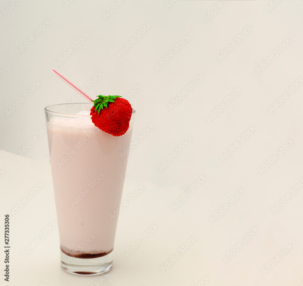Strawberry cocktail or milk shake in a glass decorated with strawberries on the table. Healthy food for breakfast and snacks. Strawberry cocktail or milk shake in a glass decorated with strawberries on the table. Healthy food for breakfast and snacks.
