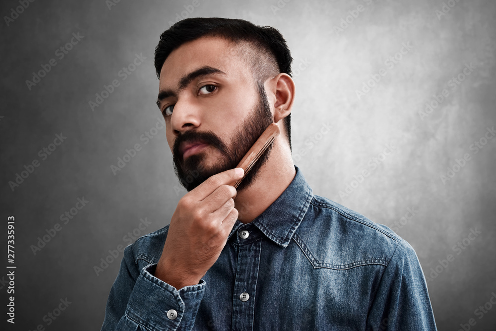 Bearded man comb his beard Bearded man comb his beard