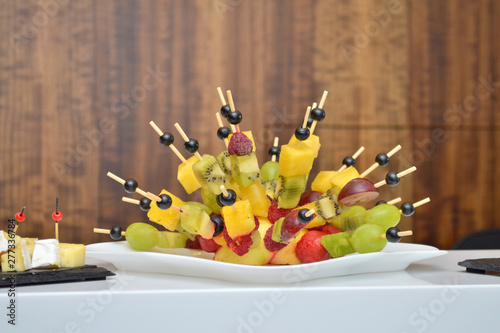 Fruity canapes in the form of a hedgehog at a banquet on the table on wooden background