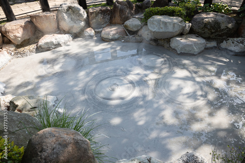 landscape view of gray mud boiling bubble hot springs at Japan. photo