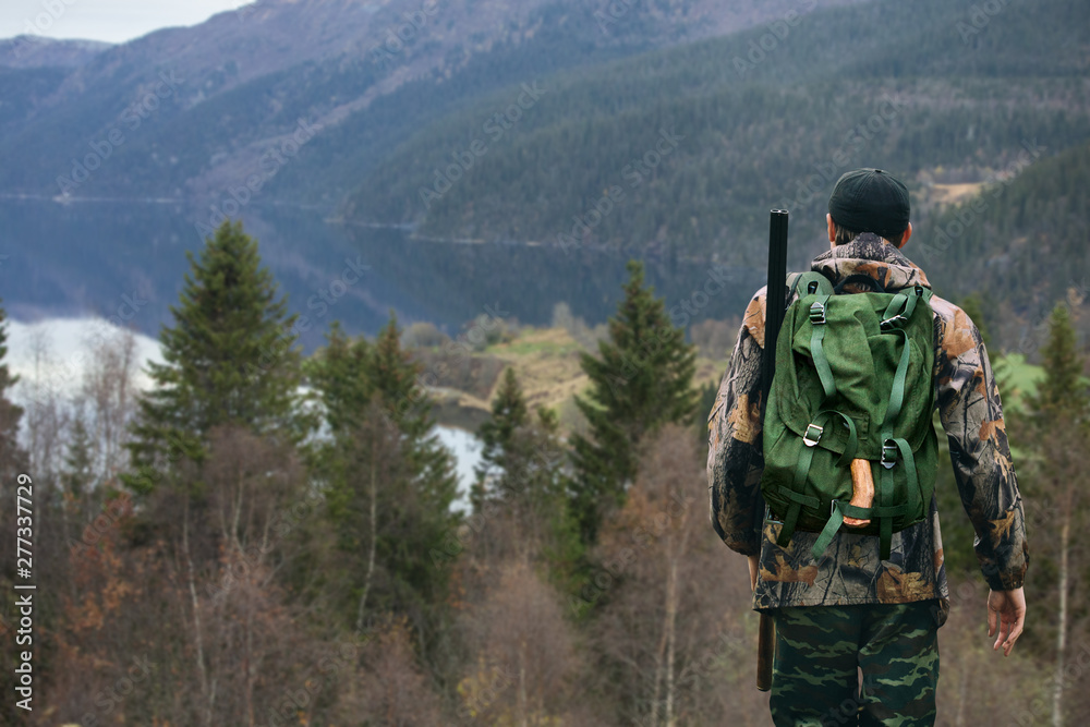 Hunter with a backpack and a gun Hunter with a backpack and a gun