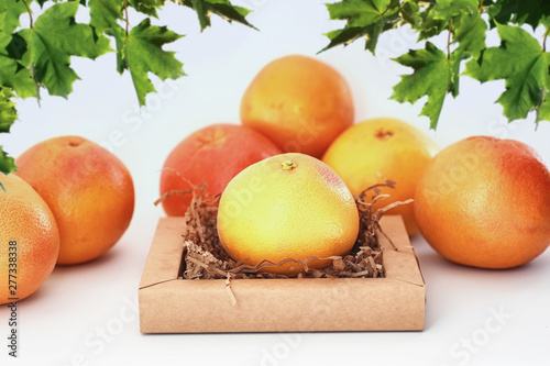Fresh juicy grapefruits on a white table