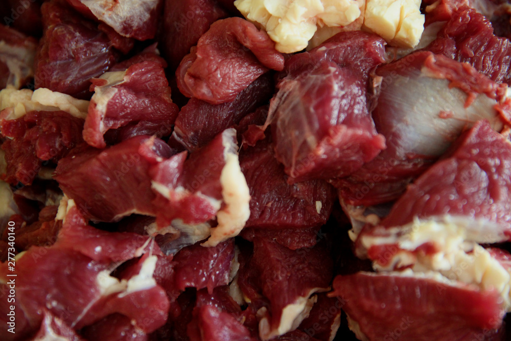 Close up view of fresh finely chopped meat cubes. Red meat small steaks with whitish meat fat. Close up view of fresh finely chopped meat cubes. Red meat small steaks with whitish meat fat.