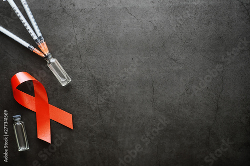Symbol of human immunodeficiency virus disease. Red ribbon. A helping hand and support.