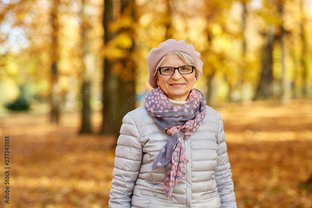 old age, retirement and season concept - portrait of happy senior woman in glasses at autumn park old age, retirement and season concept - portrait of happy senior woman in glasses at autumn park