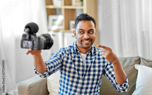 Fotografie blogging, videoblog and people concept - smiling indian male video blogger with