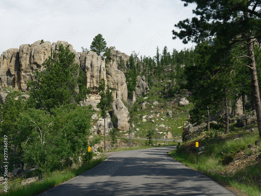 Scenic drive along a winding road with dramatic granite formations at Needles Highway in South Dakota. Scenic drive along a winding road with dramatic granite formations at Needles Highway in South Dakota.