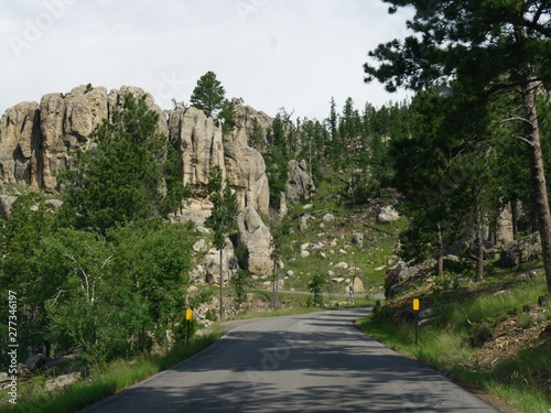 Scenic drive along a winding road with dramatic granite formations at Needles Highway in South Dakota.