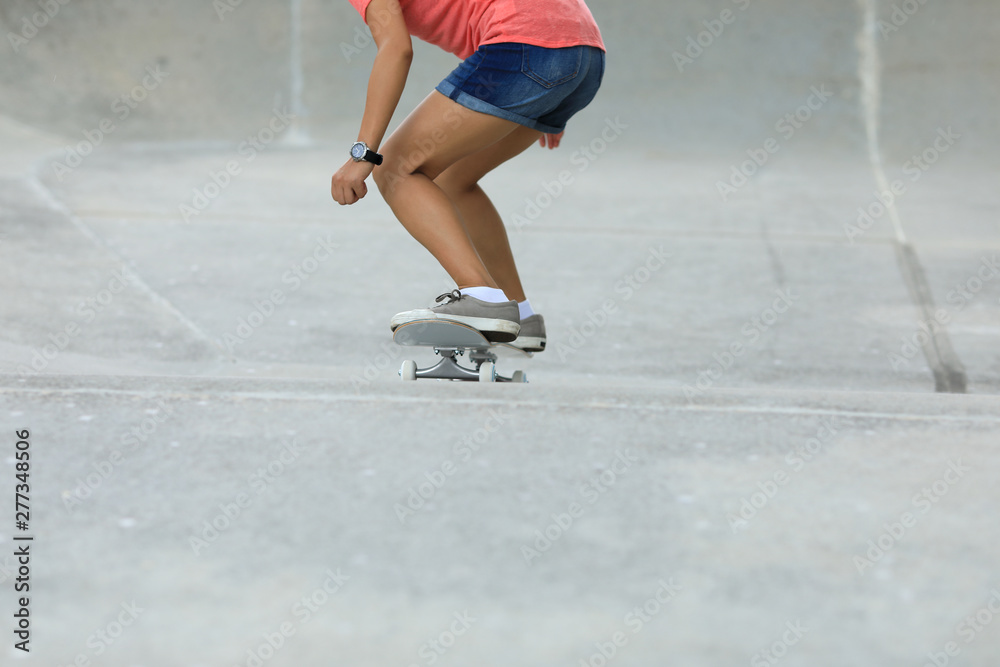 Female skateboarder skateboarding at skatepark