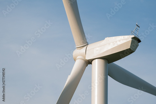 A picture of a windmill overlooking a beautiful blue sky