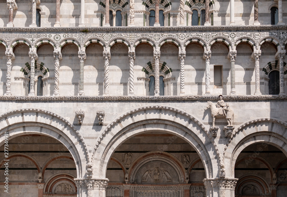 The facade of Lucca Cathedral, a Roman Catholic church dedicated to Saint Martin of Tours. The cathedral is on Piazza San Martino, a square dedicated to the same saint.
