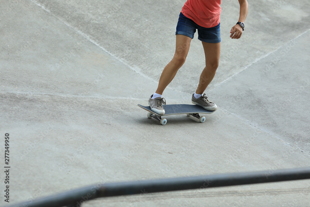 Female skateboarder skateboarding at skatepark Female skateboarder skateboarding at skatepark