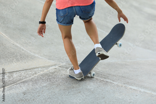 Female skateboarder skateboarding at skatepark
