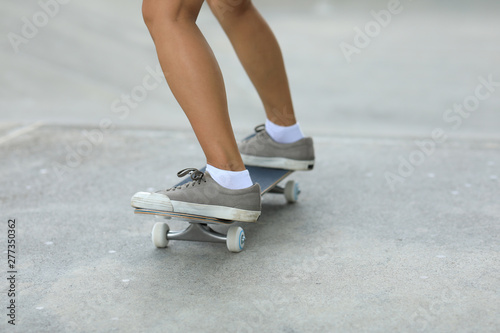 Female skateboarder skateboarding at skatepark