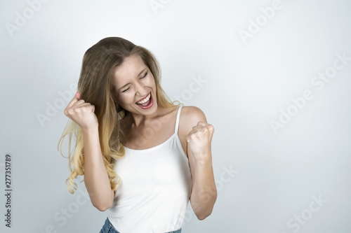 blond girl making a fist with both hands isolated white background