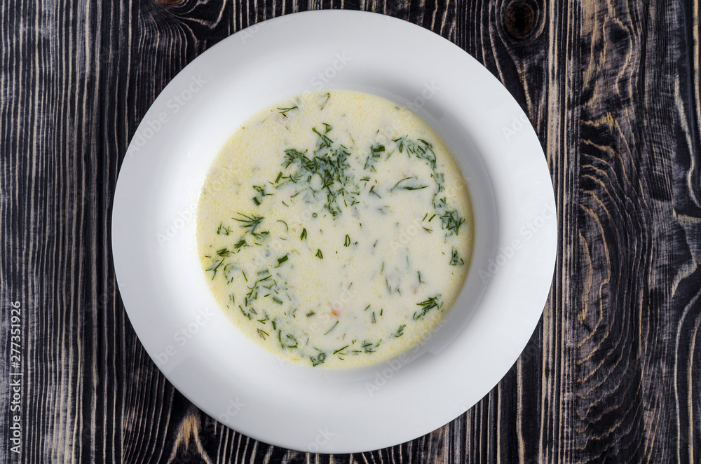 cheese soup with vegetables in a white plate cheese soup with vegetables in a white plate