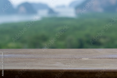 Close up top wooden table with blur landscape nature background.