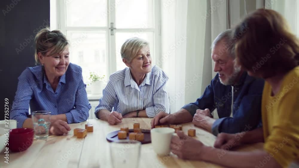 Group of senior people in community center club, playing board games. Group of senior people in community center club, playing board games.