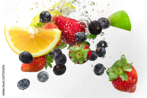 falling strawberries, blueberries, oranges, limes