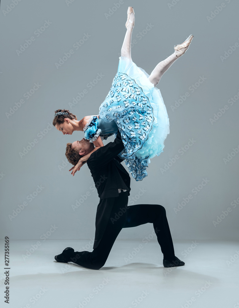 Like a cloud. Beautiful contemporary ballroom dancers isolated on grey studio background. Sensual proffessional artists dancing walz, tango, slowfox and quickstep. Flexible and weightless. - obrazy, fototapety, plakaty 