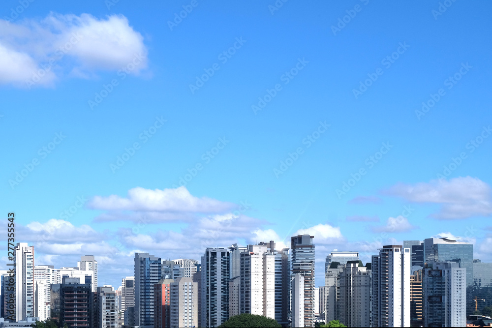 Flat cityscape with blue sky, white clouds and sun. Modern city skyline flat panoramic background. Urban city tower skyline illustration