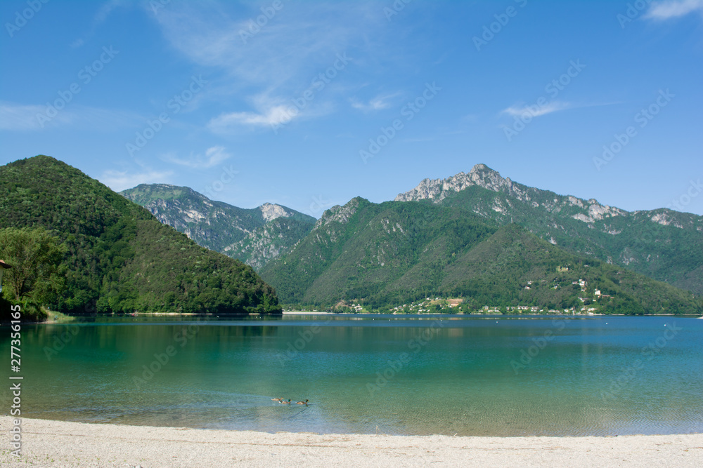 View of Lake Ledro with swimming ducks on the foreground. Trento, Italy